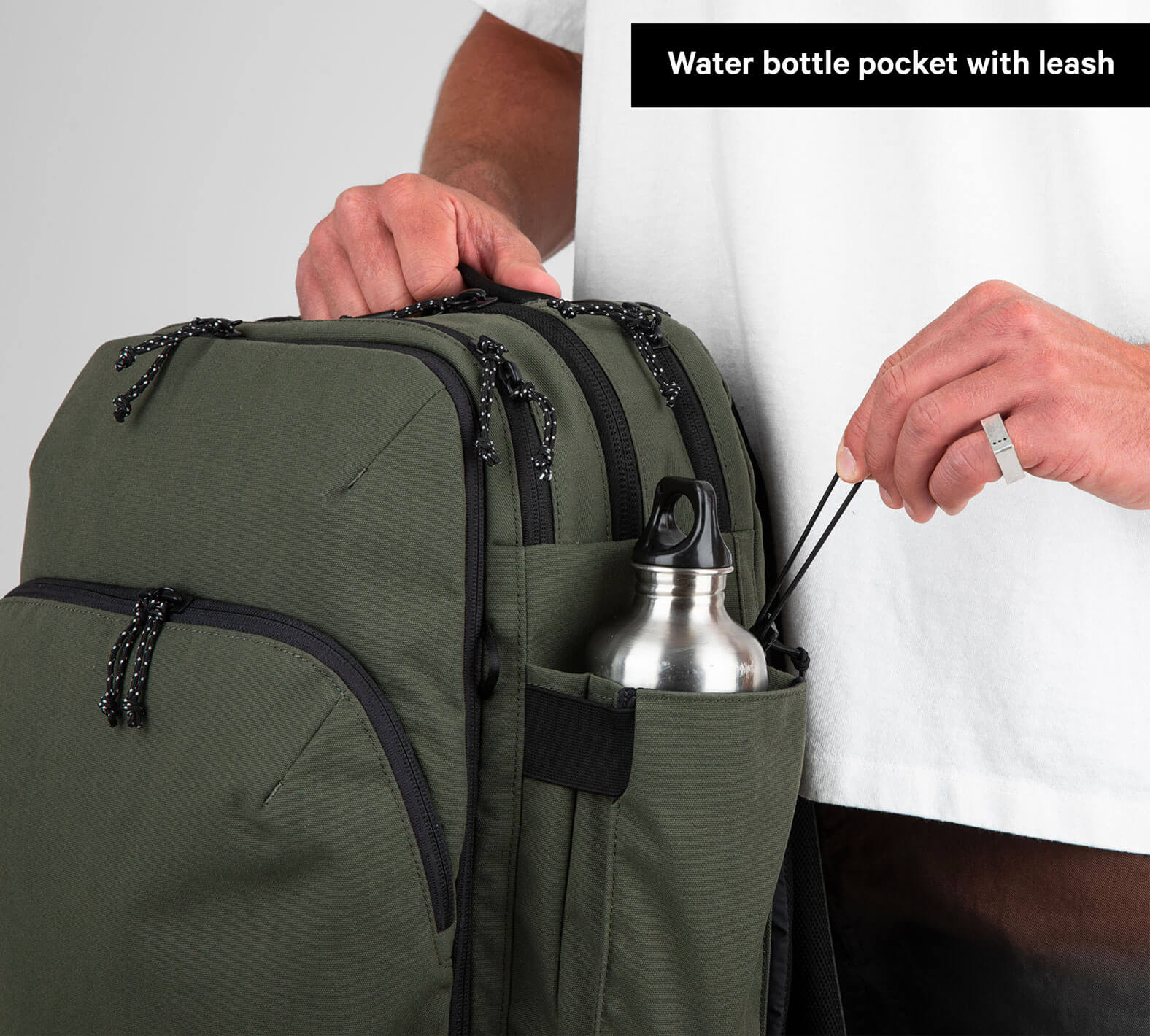 Travel Backpack Green Holding a water bottle
