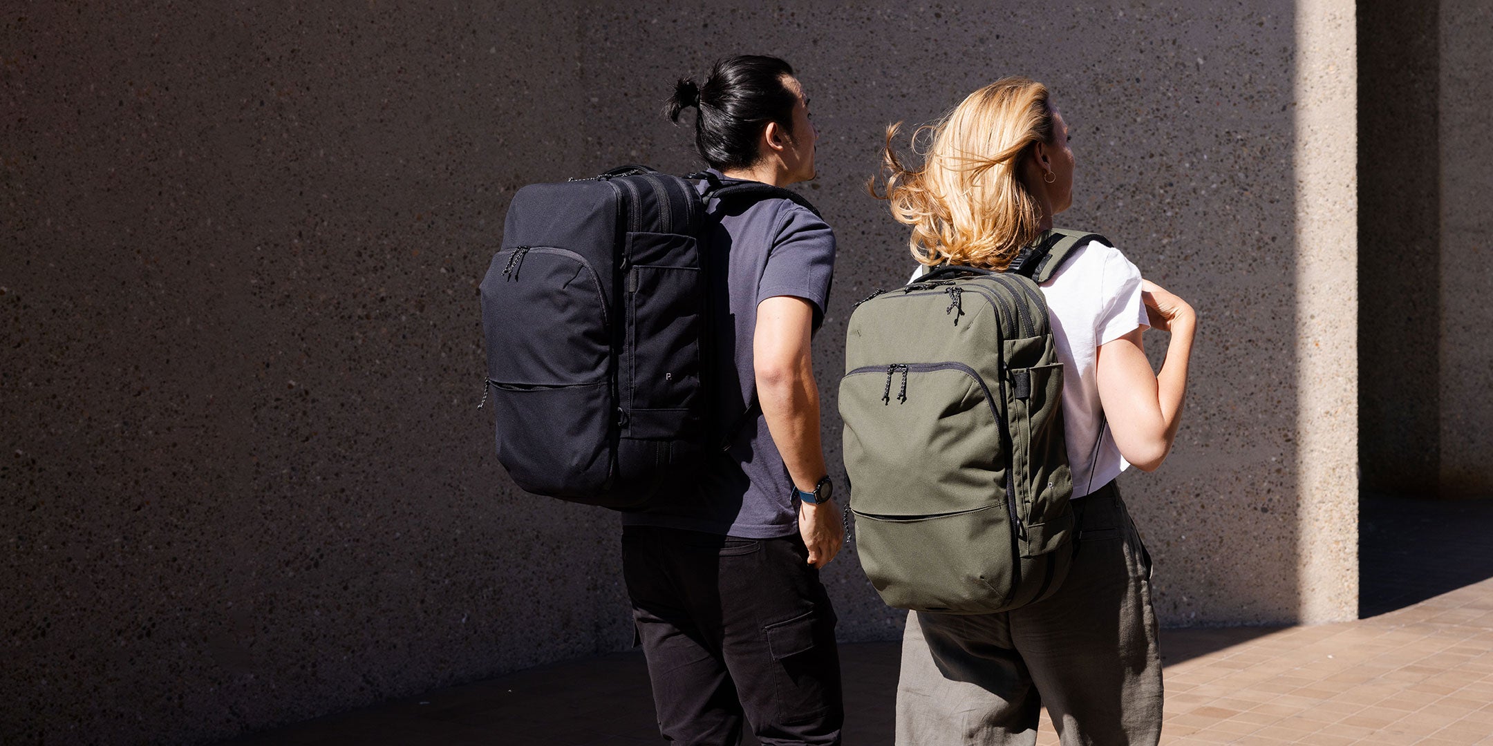 Man and Woman carrying Backpacks