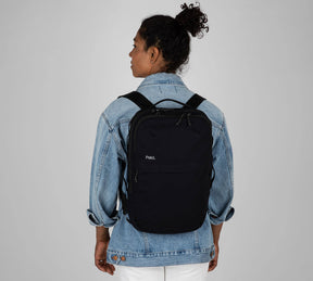 Woman with sling backpack black