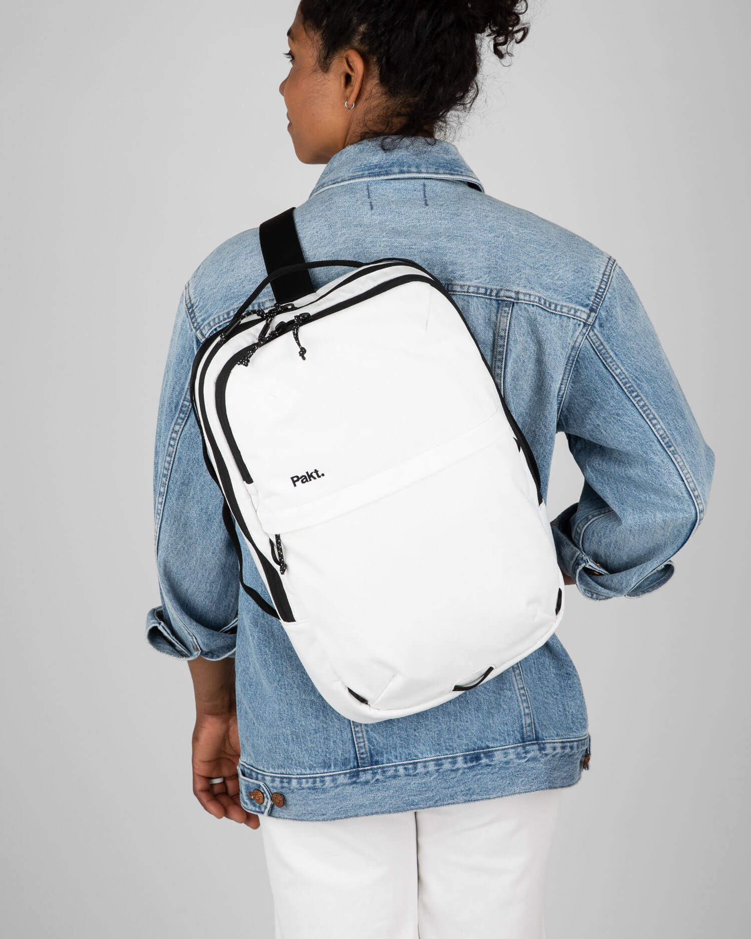 Woman carrying sling bag white